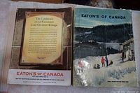 Photo of the backs of both catalogues; 1960-61 catalogue on left and 1950-51 catalogue on right showing tape and wear.