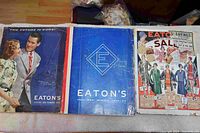 Three Eaton's catalogues arranged side by side on a table showing their front covers.