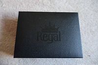 Closed black box labeled 'Regal' where cufflinks and tie bars are stored.