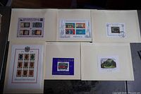 Photo showing all 6 mini souvenir sheets mounted on a backing, laid out flat for inspection