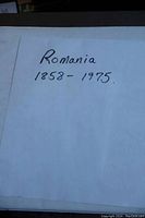 White sheet with handwritten label "Romania 1858 - 1975" indicating the years of the collection.