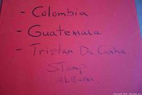 Album cover page handwritten with countries: Colombia, Guatemala, Tristan Da Cunha