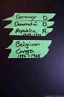 Photo showing green tape labels on black album cover indicating contents: Germany Democratic Republic 1948-1970, Belgium Congo 1886-1965