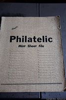 Cover of the album reads 'Philatelic Mint Sheet File' with space for numbering entries.