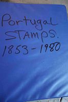 Blue cover of the stamp album with handwritten label Portugal Stamps 1853-1980.