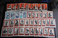 Sheet of Russian stamps with images of statues and busts of historical figures, orange and white themed.