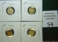 Photo of the front side (obverse) of four silver dimes dated 1902, 1912, 1915, and 1917, each mounted in individual cardboard holders with handwritten dates.