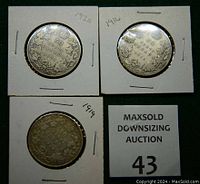 Reverse sides of the three coins showing denomination and year: 1920, 1916, 1919 Canadian silver 50 cent coins in cardboard holders.