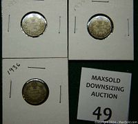 Reverse side of the 1931, 1935, and 1936 silver dimes in white cardboard holders with pin staples and the lot number card.