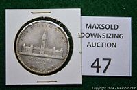 Front side of the coin showing the Parliament building and inscriptions