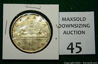 Reverse view of 1960 Canada silver dollar coin displaying the voyageur canoe design and year 1960.