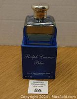 Photo of partial bottle of Ralph Lauren Blue Eau de Toilette 75 ml on blue box