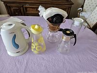 Full set of 5 items on table including electric kettle, juice jug, milk jug, coffee pot, and pour-over coffee maker.
