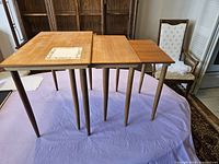 Set of 3 teak nesting tables arranged side by side showing size variations and condition