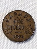 Reverse side of a 1926 Canadian one cent coin showing the date, 'CANADA', 'ONE CENT', and two maple leaves with good detail despite circulation wear.