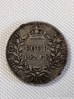 Full view of the 1935 British Silver Four Pence coin showing denomination, date, and lettering.
