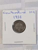 Photo showing the full coin mounted on a card labeled "Newfoundland 10d 1938"