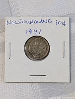 Photo of front side of the 1941 Newfoundland 10 Cents silver coin in holder, showing denomination and year with floral wreath design.
