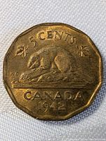 Reverse side showing a beaver on log, maple leaves, and coin details.