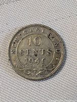 Obverse side of 1946 Newfoundland 10 cent silver coin showing denomination and year.