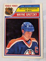 Front of 1984-85 OPC Wayne Gretzky hockey card showing player in Oilers jersey.