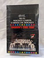Front of sealed 1990-91 OHL hockey cards wax box with colorful star accents and team photo