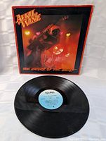 Photo of April Wine The Nature Of The Beast LP vinyl record with blue label and sleeve showing guitarist on stage