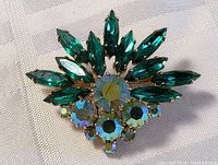 Front view of the aqua burst vintage costume brooch showing faceted marquise and round stones in gold-tone setting.