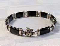 Sterling silver and onyx bracelet laid flat showing clasp and length.