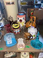 Overview photo capturing all various pottery and glass items on display, including cookie jar, vases, butter dish, and spoon rest.