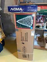 Original boxed 6-foot Kettlestone Spruce tree with smaller box for wreath stacked on top