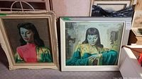 Two framed portrait prints on wood boards showing Asian women in traditional or vintage clothing, with different poses and color schemes.
