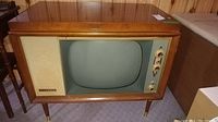 Full view of the Sparton vintage console television showing wooden cabinet, CRT screen, speaker grille, and control knobs.