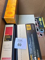 Photo showing several Kodak Carousel Transvue 80 slide trays in original boxes plus loose slides, Sigma film box also visible.