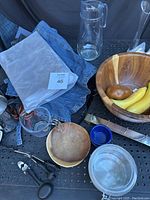 Overview of items including apron, wooden bowls, measuring cup, scissors, corkscrew and skewers.