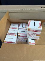 Box containing multiple smaller boxes of GE Halogen IR flood light bulbs, some opened.