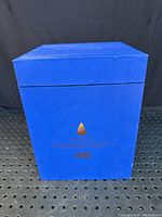 Original blue box with Tom Dixon branding and minor dings visible on edges.