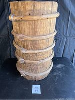 Full front view of tall wooden grain barrel showing entire height and structure.