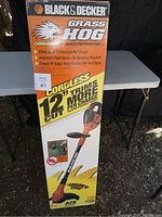 Box showing front of Black & Decker Grass Hog 12" cordless trimmer/edger with branding and key features.
