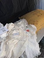 Ivory and cream colored duvet cover and top sheets with visible fabric texture and tags.