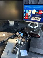 View of all electronics together including Dell monitor, Asus monitor, Sony Blu-Ray players and cables.