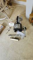 Kenmore food processor with cutter attachment, Toastmaster hand mixer, Westinghouse electric cutter, and flour sifter on floor.