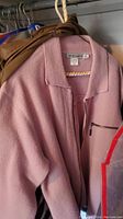 Pink zip-front wool-blend jacket on hanger
