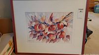 Full view of the framed watercolor painting showing red apples and surrounding leaves on branches.