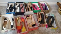 Full lot showing 12 pairs of women's shoes boxed or stored in plastic containers, various styles and colors mainly size 7-8