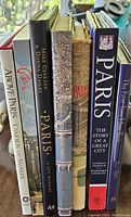 Side view of the set of seven large photo/history books on Paris with titles visible on spines.