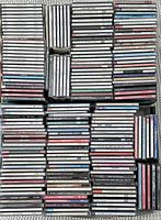 Top-down view of 150+ classical and opera CDs stacked showing cases with titles and artists visible, some with scratches and wear.