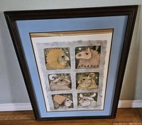 Full view of framed lithograph print with six stylized portraits and blue matting, shows overall condition and framing