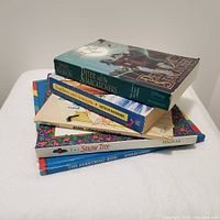 Stack of five children's books showing titles and partial cover art