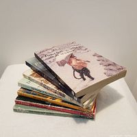 Stacked view of seven paperback books from The Chronicles of Narnia series by C.S. Lewis, showing titles and colorful spines.